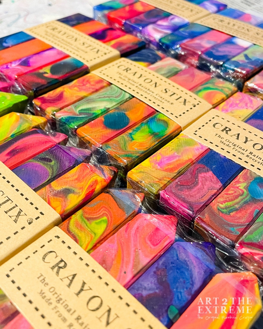 9 packs of Crayon Stix® rainbow crayon gift for kids from Art 2 the Extreme. Each 4 pack of square Crayon Stix® comes in multicolors and has a Brown band around them that Says Crayon Stix The original Rainbow Crayon, Made from Recycled Crayons.