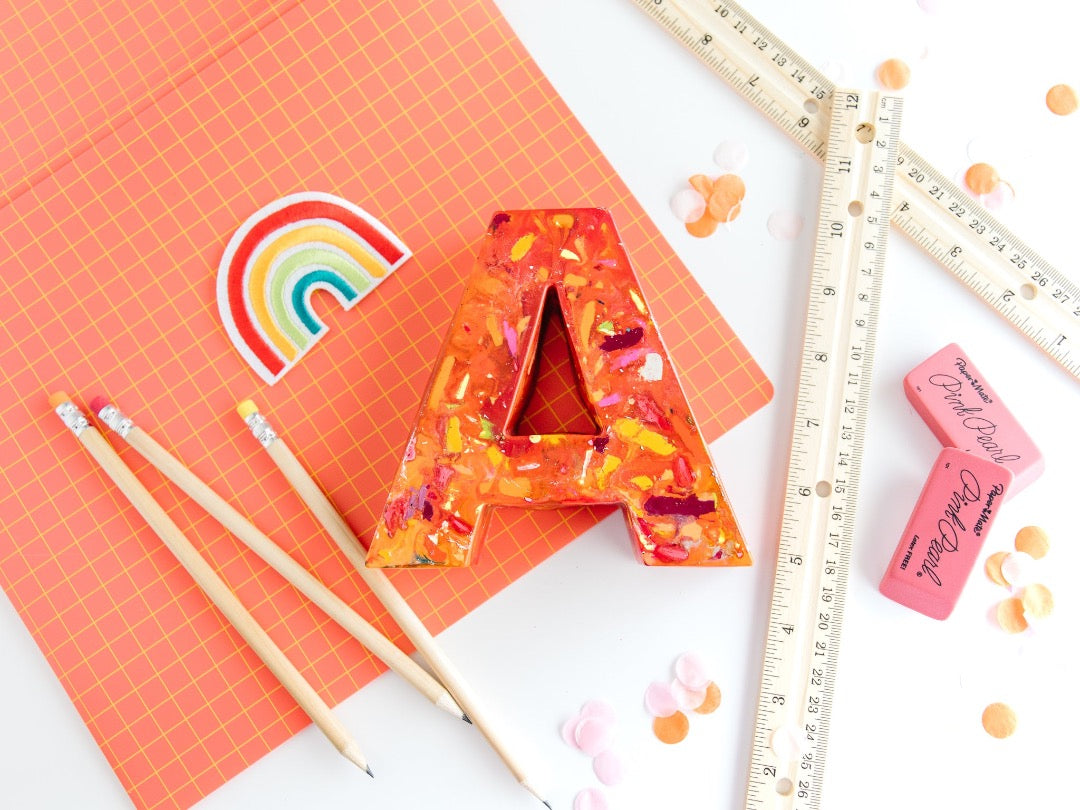 Large letter A crayon in orange and warm colors. This oversized crayon is a perfect teacher gift idea. Choose your own colors in rainbow crayon order.  Average rating value of 5 out of 5.