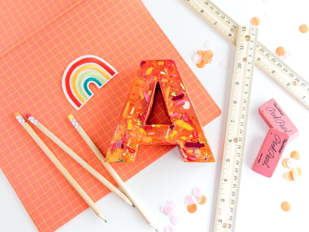Large letter A crayon in orange and warm colors. This oversized crayon is a perfect teacher gift idea. Choose your own colors in rainbow crayon order. Average rating value of 5 out of 5.