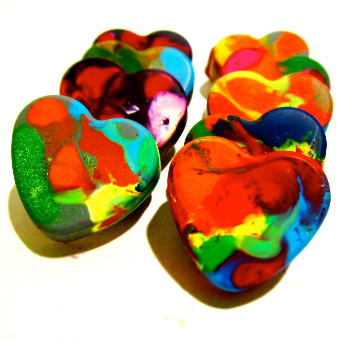 Colorful heart-shaped crayons with a vibrant swirl of rainbow colors, handmade by Art 2 the Extreme. These unique crayons are perfect for kids' valentines day for classmates, Valentine gifts, or fun valentine classroom activities.