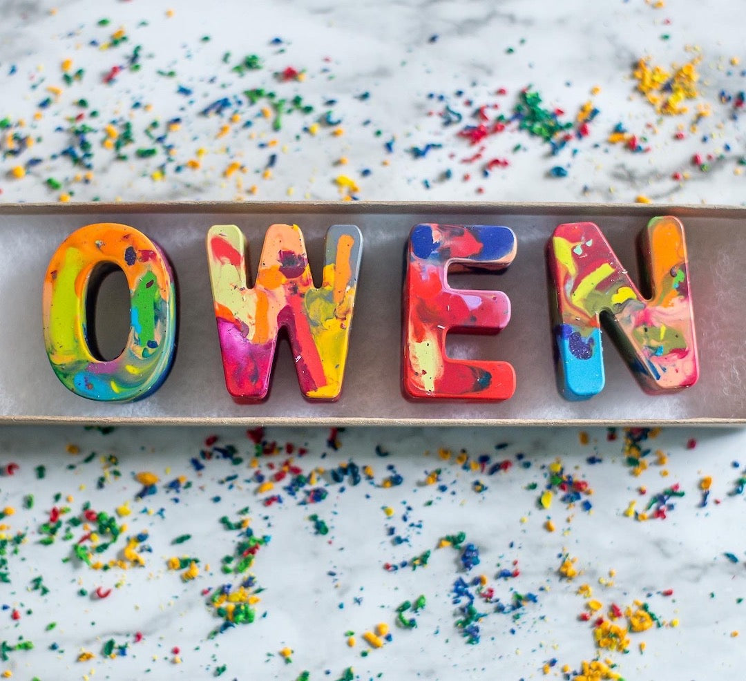 Custom crayon name set by Art 2 the Extreme that spells the name OWEN. Crayon letters are made from colorful recycled crayons and come in a personalized gift box.