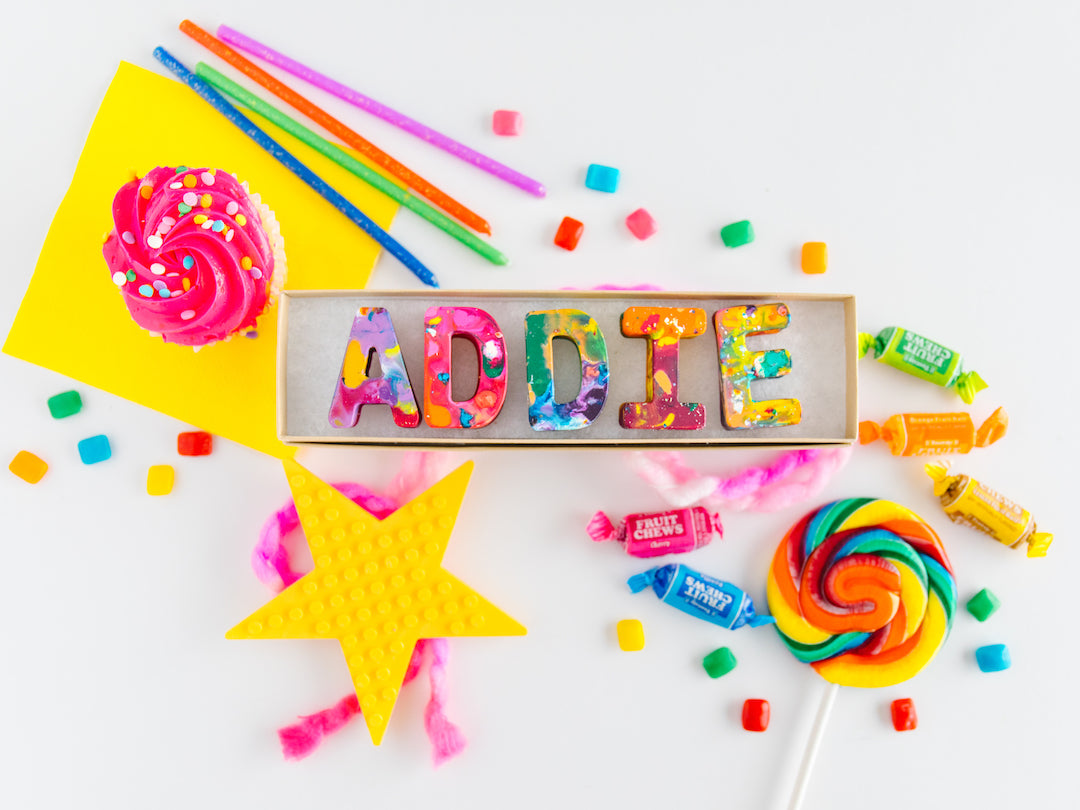 Crayon party favors name set that spells the name ADDIE in colorful, oversized rainbow crayon letters. This personalized crayon set comes in a kraft colored gift box and is ready to gift. This would make a great back to school gifts for kids. 
