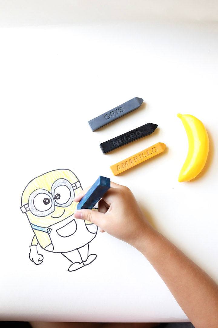 Child colors a hand-drawn minion from a how to draw Minions project using a blue, Azul Spanish color crayon from Art 2 the Extreme.