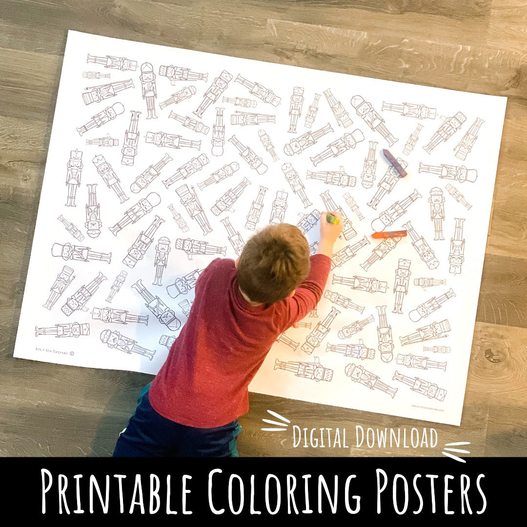 A young boy lays down on a giant black and white coloring poster with nutcracker soldiers printed all over the paper. He is using an Original Rainbow Crayon to color this poster for coloring wrapping paper.  