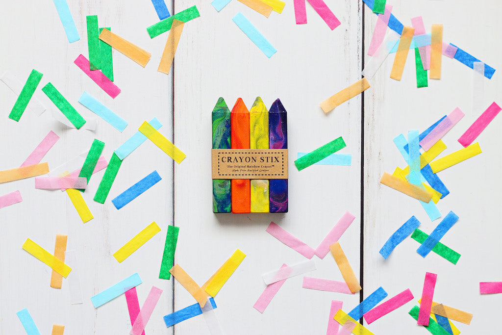 Pack of 4 multicolored crayons called Crayon Stix on a white background with confetti crayon paper.  Original Rainbow Crayons, made from recycled rainbow Crayola crayons, Selling from crayon shop, Art 2 the Extreme® Crayon Gift for Kids, Arts and Craft Supplies